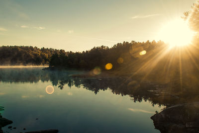 Sun shining over calm lake