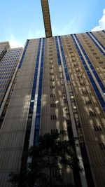 Low angle view of modern buildings against blue sky