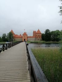 Building by lake against sky