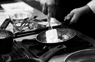 Midsection of person preparing food in kitchen