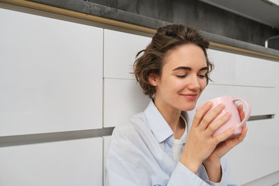 Portrait of young woman using mobile phone