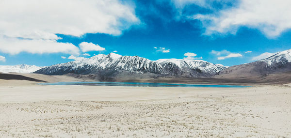 Scenic view of snowcapped mountains against sky