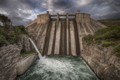 View of dam against cloudy sky