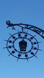 Low angle view of street light against blue sky