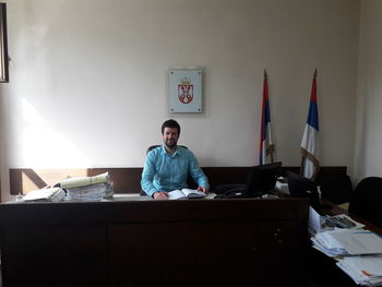 Portrait of man sitting at desk in office