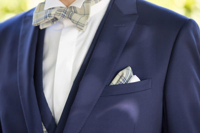 Midsection of man wearing suit