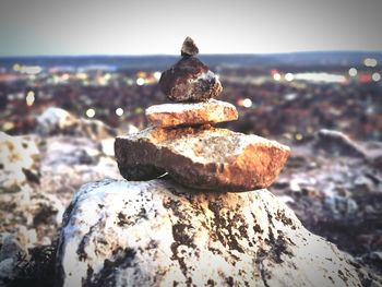 Close-up of stone stack on rock at beach