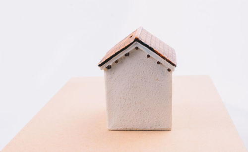 Close-up of birdhouse against white background