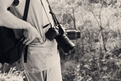 Rear view of man holding camera