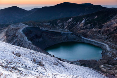 Scenic view of river amidst mountains against sky