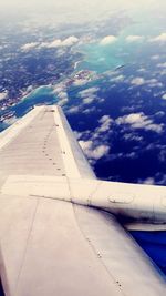 Cropped image of airplane flying over sea