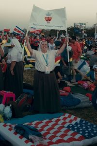 Rear view of people standing in front of flags