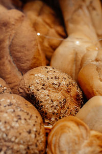 Fresh baked multigrain bread in a wicker basket in a baked goods store. vertical