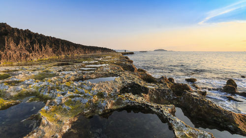 Scenic view of sea against sky during sunset