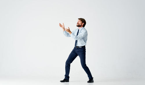 Full length of man standing against white background