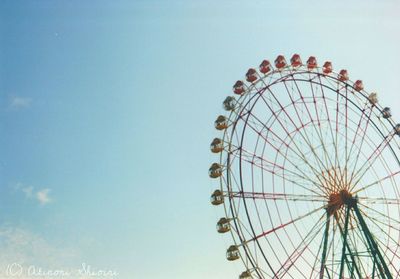 Low angle view of ferris wheel against sky