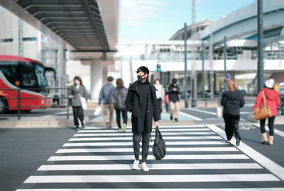 People crossing road in city