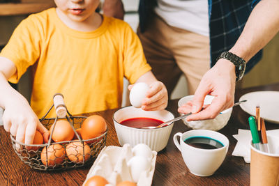 Easter day. cropped father and son painting eggs. family preparing for easter, creative homemade