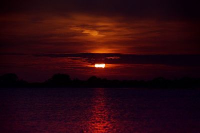 Scenic view of sea against romantic sky at sunset