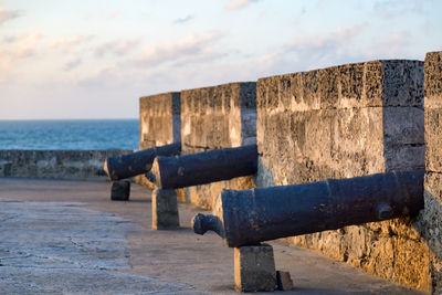 Close-up of groyne by sea against sky