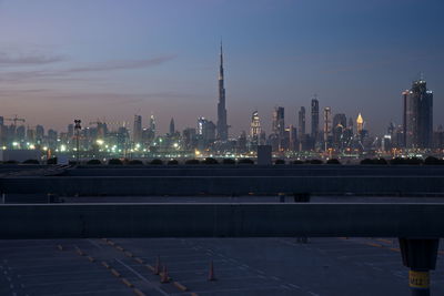 Illuminated city buildings against sky