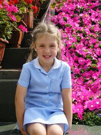 Portrait of smiling girl sitting outdoors