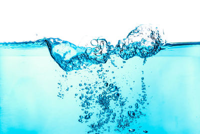 Close-up of bubbles over sea against white background