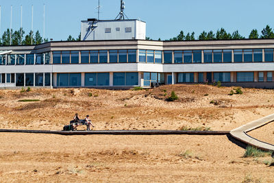Man by building against sky