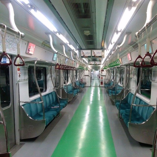 transportation, indoors, mode of transport, in a row, public transportation, vehicle interior, diminishing perspective, land vehicle, empty, vehicle seat, architecture, built structure, travel, incidental people, the way forward, ceiling, absence, interior, no people, passenger train