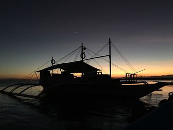 Silhouette of ship at sunset