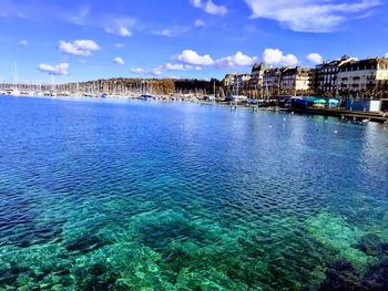 Panoramic view of sea and buildings against sky