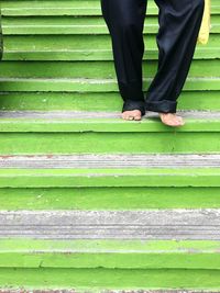 Low section of man standing on staircase