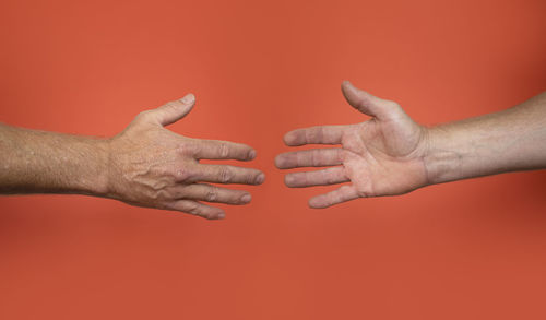 Close-up of hand against red background