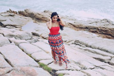 Portrait of young woman standing on beach