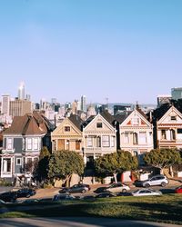 Buildings in city against clear sky