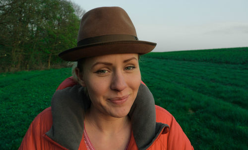 Portrait of woman wearing hat on field