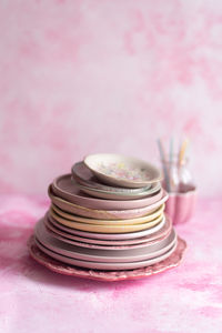Ceramic plates on a pink background