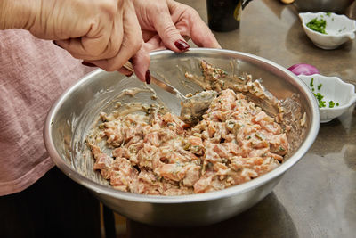 Cropped hand of person preparing food