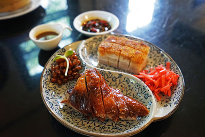 Close up crispy pork belly served with roasted barbecue duck- chinese food