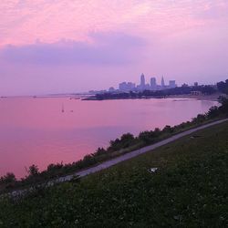 View of city at waterfront during sunset