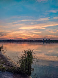 Scenic view of lake against sky during sunset