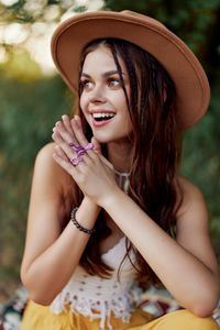 Portrait of young woman wearing hat