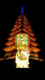 Illuminated building against sky at night