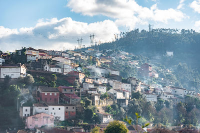 Buildings in town against sky