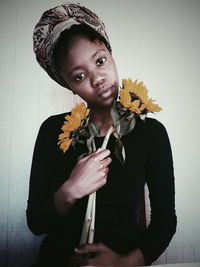 Portrait of young woman holding flower