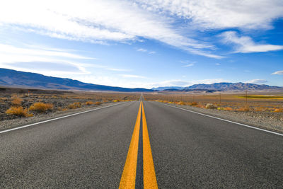 Road passing through landscape against sky