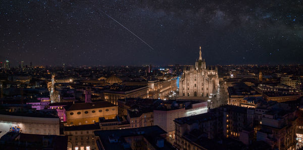 Aerial view of piazza duomo in front of the gothic cathedral in the center of milan at night.