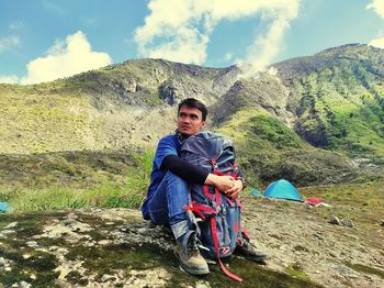 Portrait of man on mountain against sky