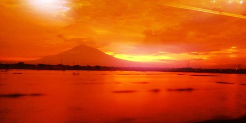 Scenic view of lake against sky during sunset