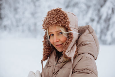 Portrait of a young girl in the winter forest